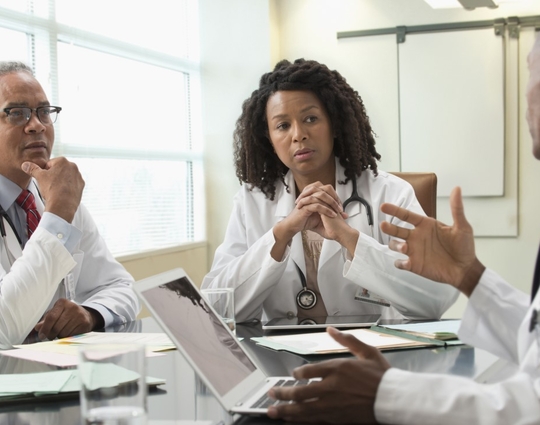 Doctors talking in office meeting