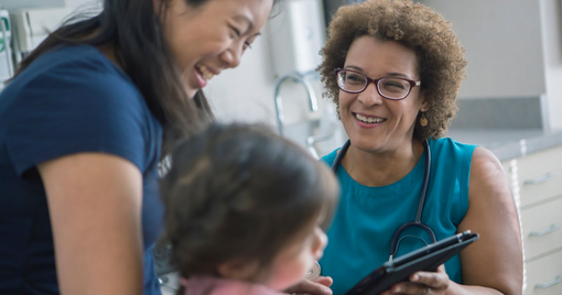 Doctor using digital tablet with patients