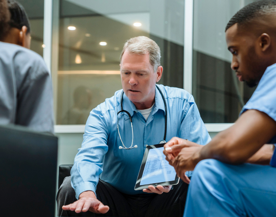 Three healthcare professionals in a meeting. 