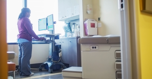 Nurse at a mobile computer desktop