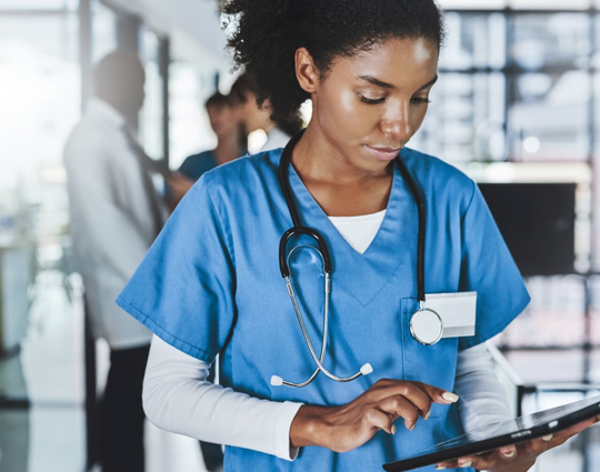 Medical professional looking at a computer tablet