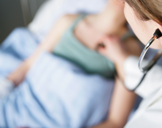 medical professional checking a patient's vital signs