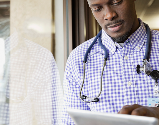 Care provider working on a tablet in a hospital